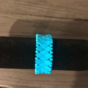 One size , blue stretchable bracelet . No clasps slides on and off .